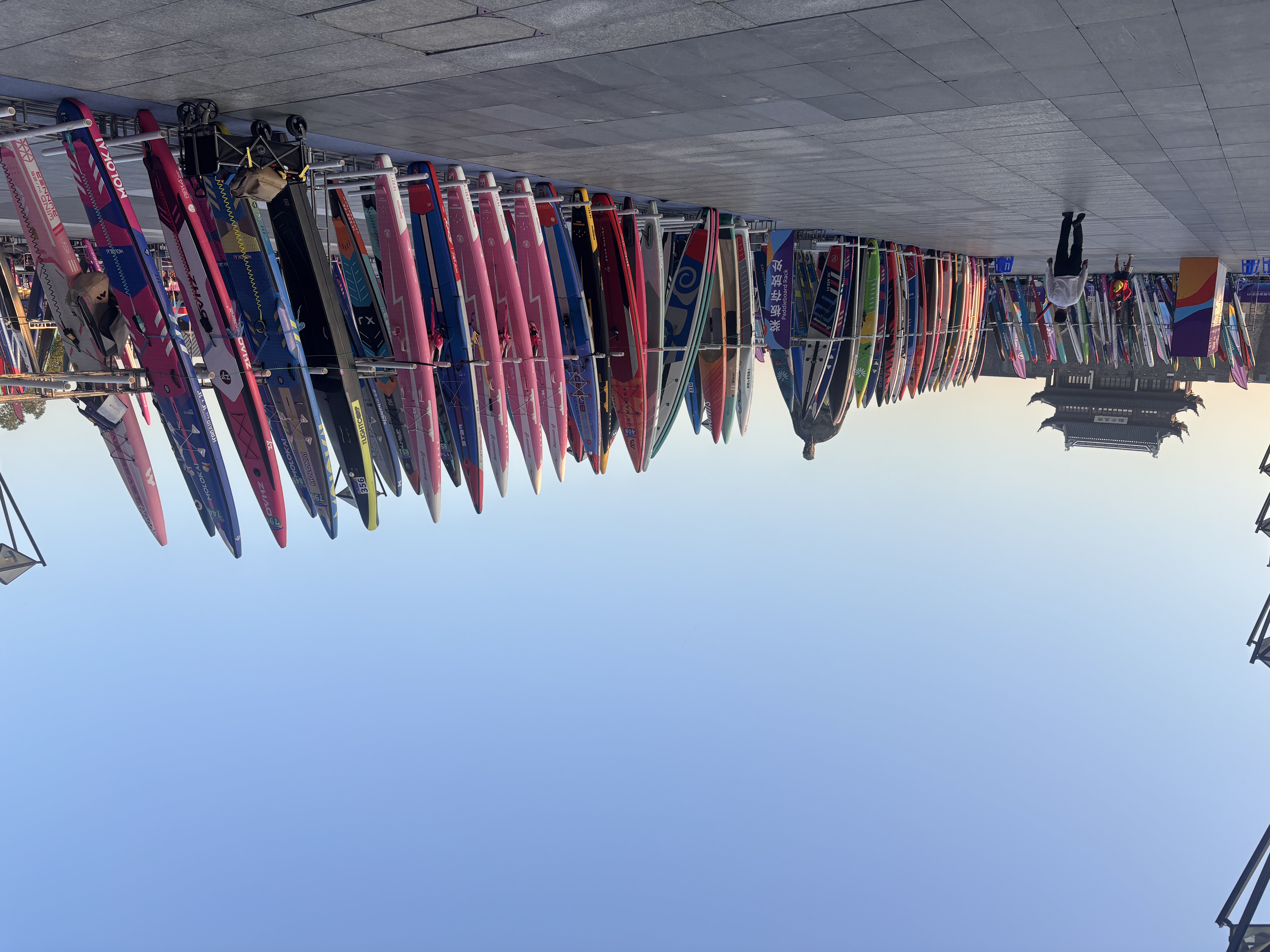 Long rows of SUP board racks in the event plaza