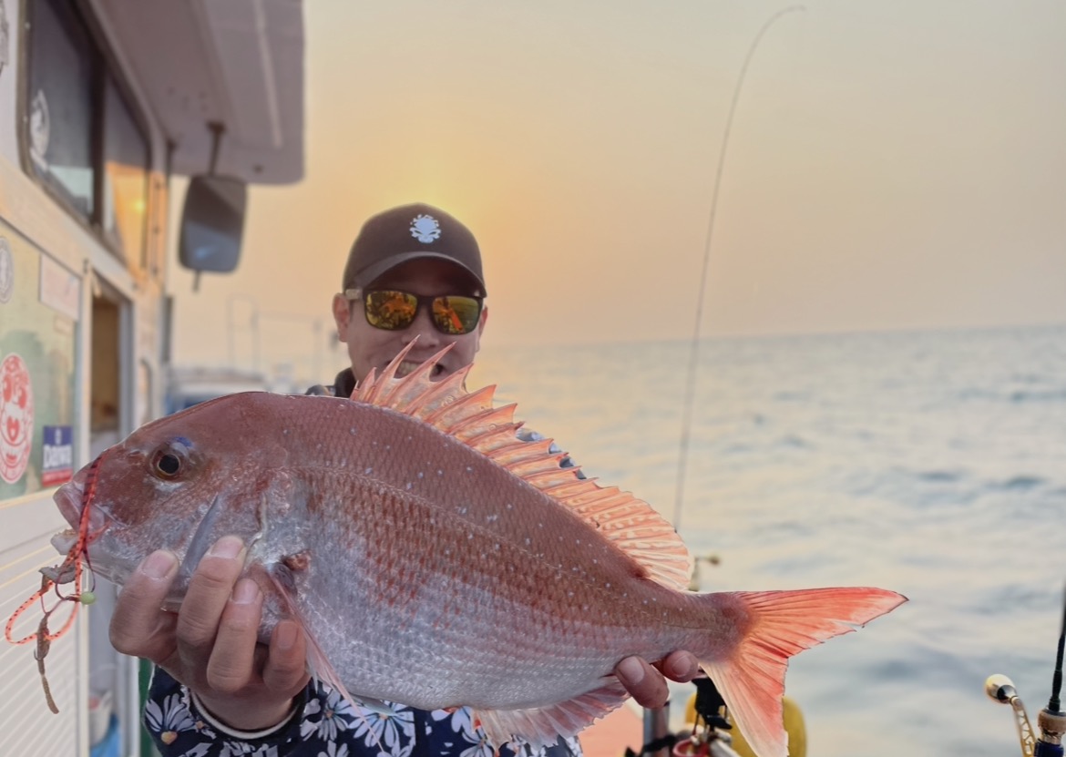 Ahn Sugon with his catch at sunset