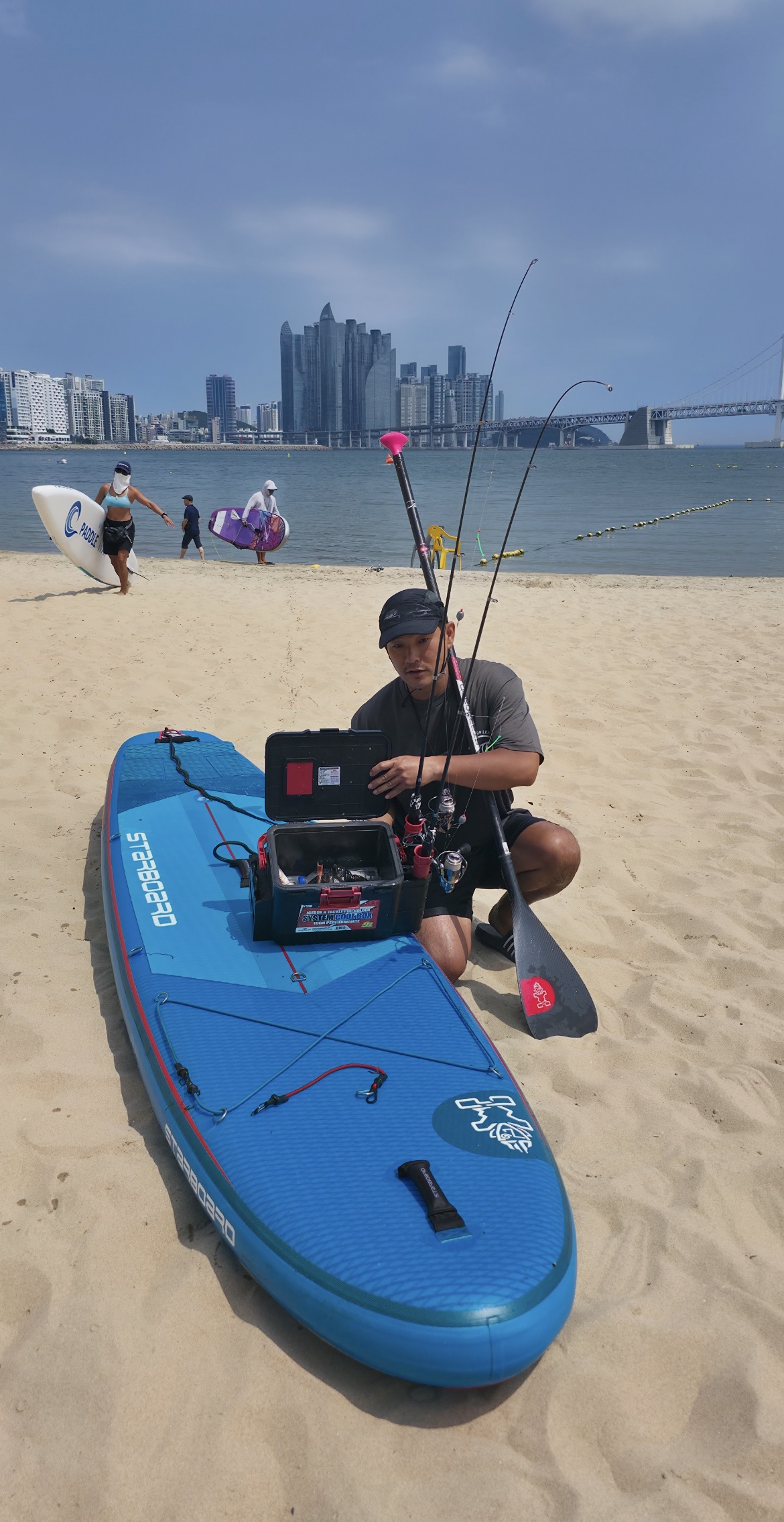 Ahn Sugon preparing a Starboard SUP and fishing equipment